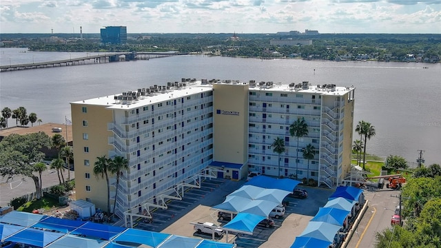 birds eye view of property with a water view and a city view