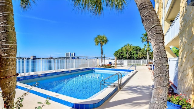 pool featuring a fenced backyard and a patio