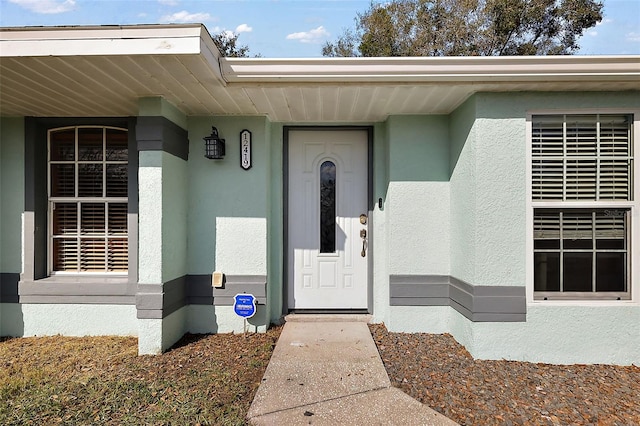 property entrance featuring stucco siding