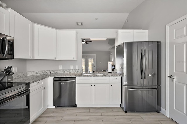 kitchen with light stone counters, stainless steel appliances, a sink, visible vents, and white cabinets