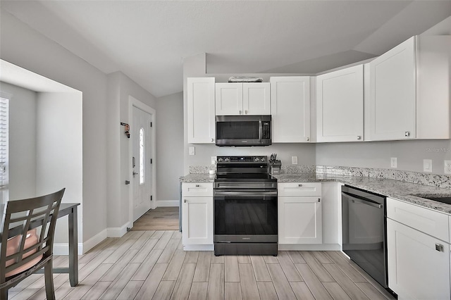 kitchen featuring stainless steel appliances, white cabinetry, and wood tiled floor