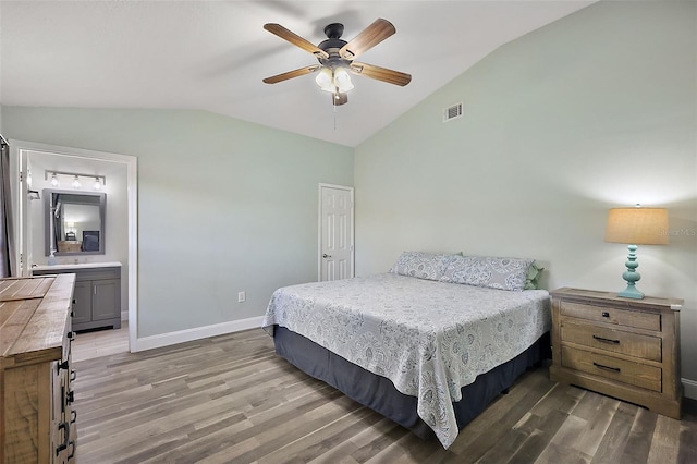 bedroom featuring lofted ceiling, visible vents, baseboards, and wood finished floors