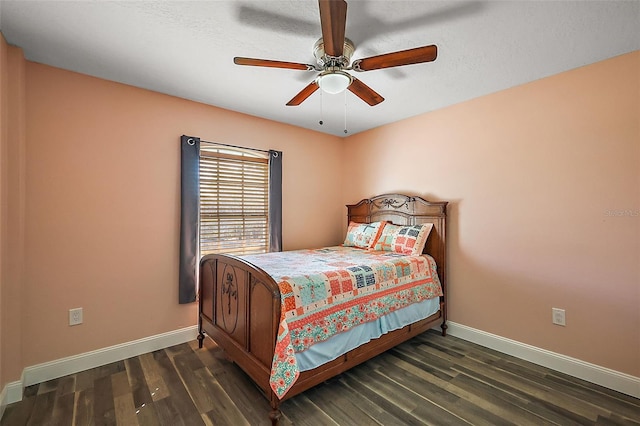 bedroom featuring wood finished floors, a ceiling fan, and baseboards