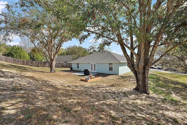 exterior space featuring fence and stucco siding