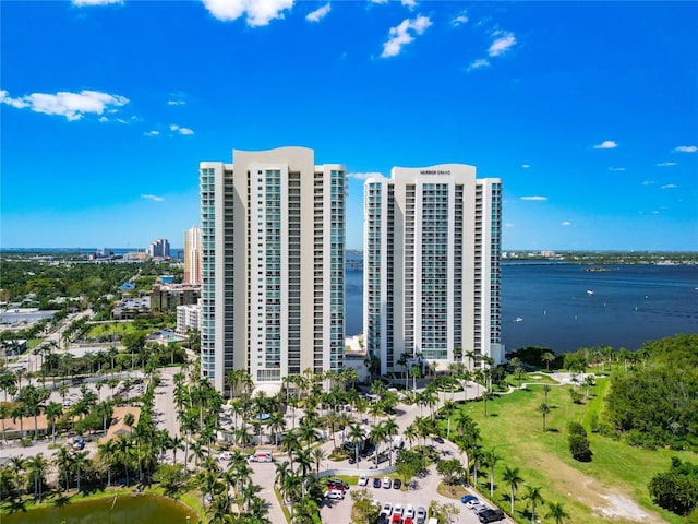 birds eye view of property with a water view and a city view