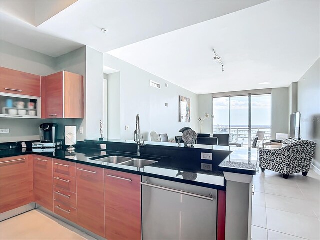 kitchen featuring floor to ceiling windows, open floor plan, a sink, dishwasher, and a peninsula