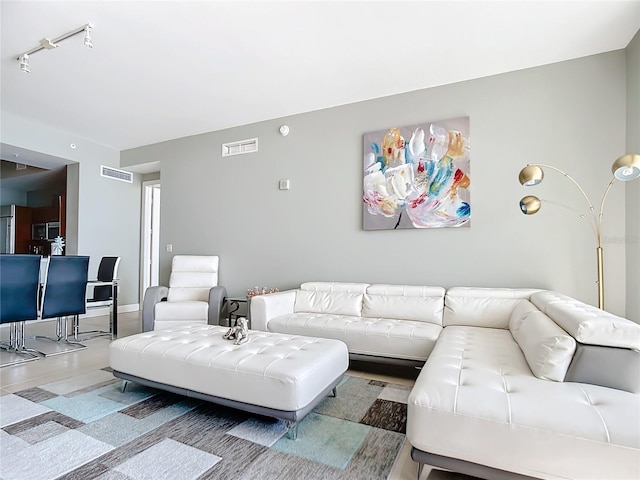 living room with visible vents and baseboards