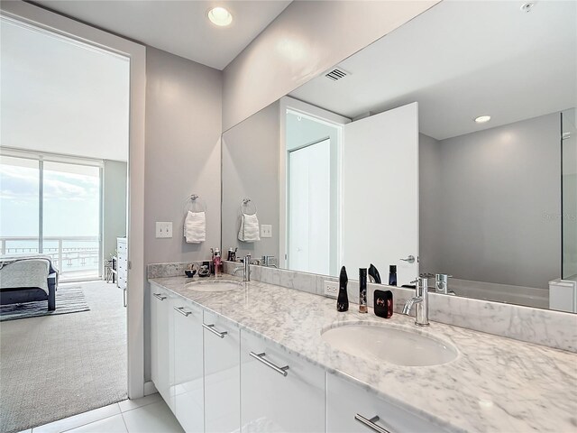 bathroom with double vanity, visible vents, a sink, and recessed lighting