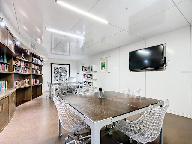 dining space with finished concrete flooring and visible vents