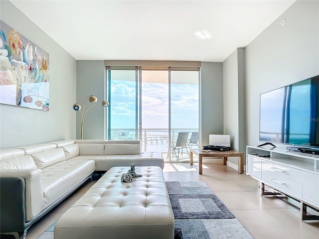 living room featuring floor to ceiling windows and light tile patterned floors