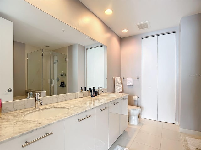 bathroom with tile patterned flooring, a sink, toilet, and a shower stall