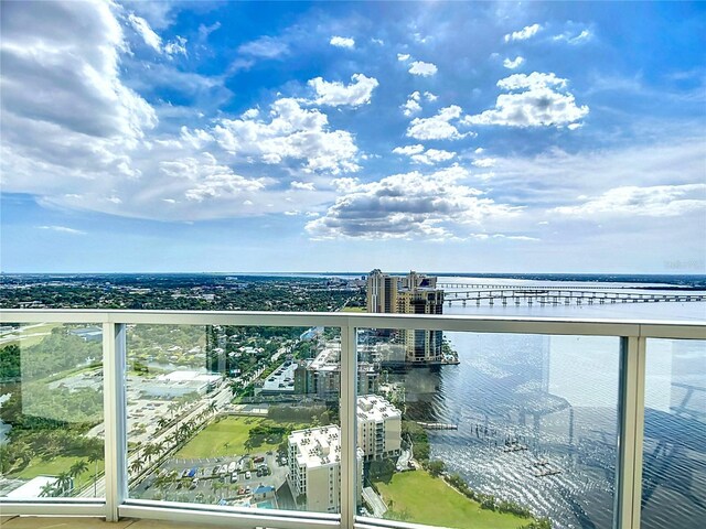 balcony featuring a view of city and a water view