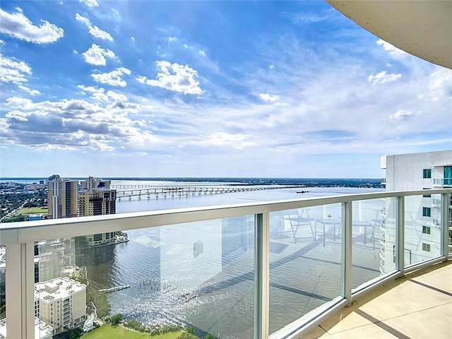 balcony with a view of city and a water view