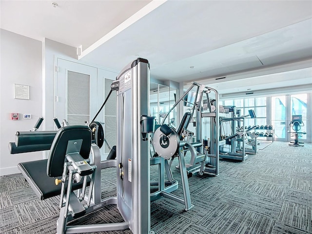 exercise room featuring carpet floors and baseboards