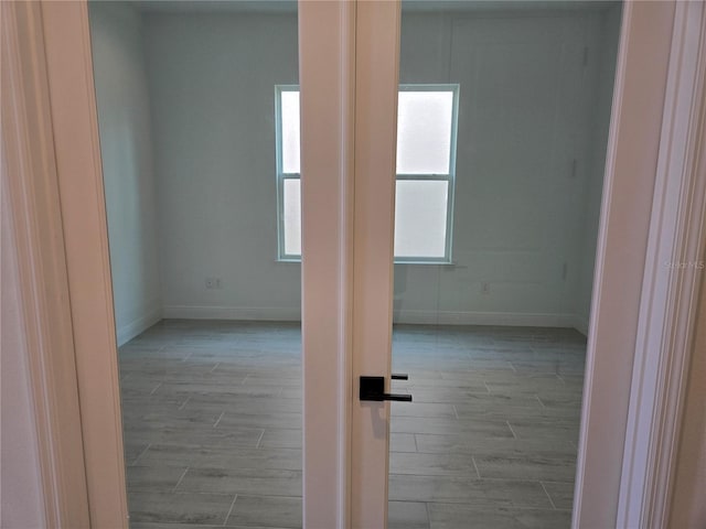 empty room with wood finish floors and baseboards