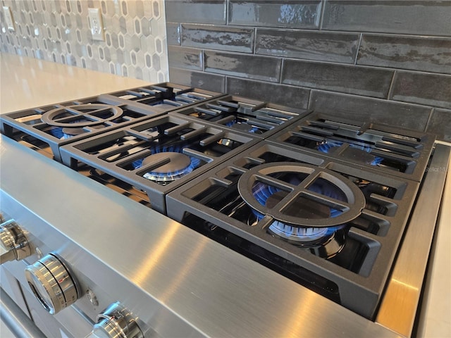 room details featuring tasteful backsplash and gas cooktop