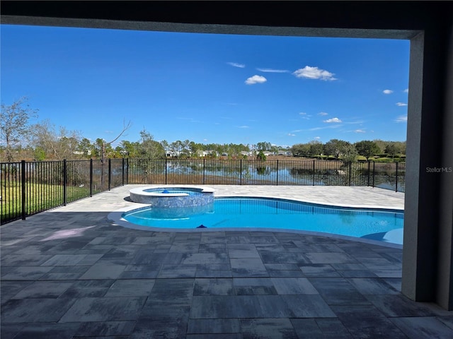 view of pool featuring a water view, a pool with connected hot tub, and fence