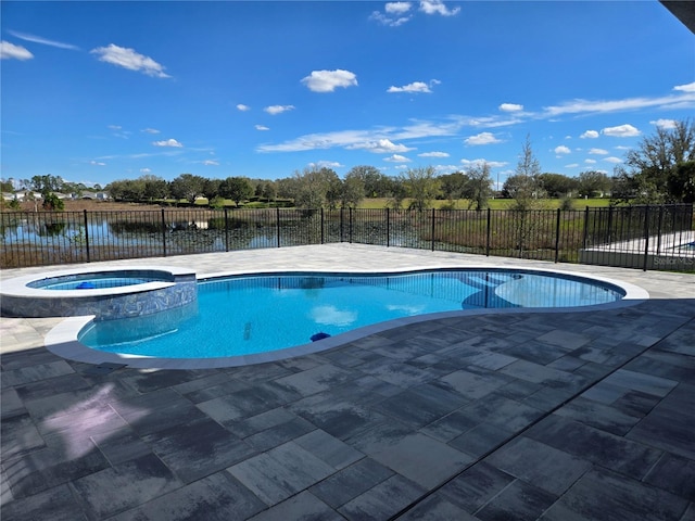 view of pool featuring a patio, fence, and a pool with connected hot tub