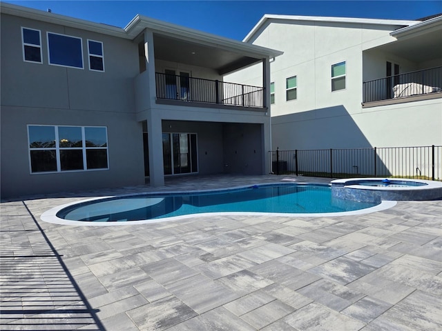 view of pool featuring a pool with connected hot tub and a patio