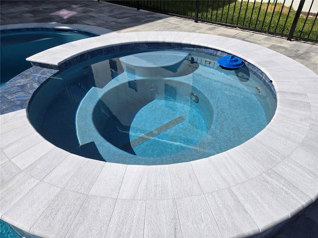 view of pool featuring a pool with connected hot tub