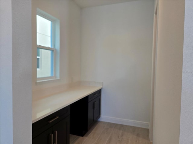 interior space featuring light wood-style floors and baseboards