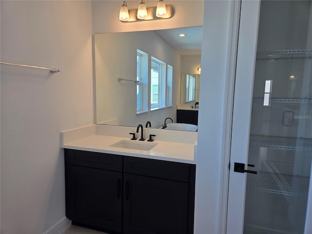 full bathroom featuring baseboards and vanity