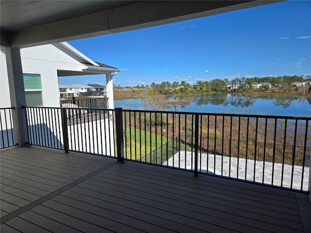 wooden terrace featuring a water view