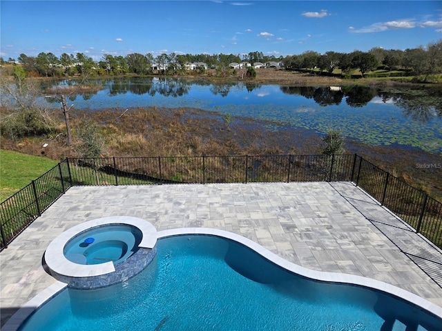 view of pool with a pool with connected hot tub, a water view, a patio, and fence