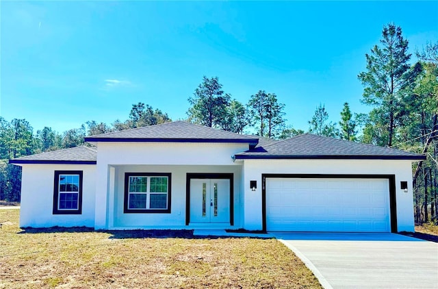 ranch-style home with a garage, french doors, driveway, and stucco siding