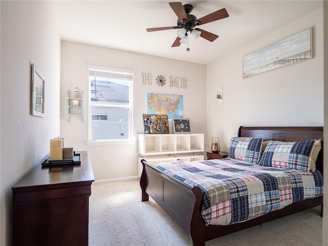 bedroom featuring carpet floors, baseboards, and a ceiling fan