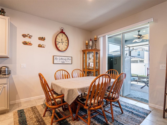 dining room featuring light tile patterned floors, ceiling fan, and baseboards