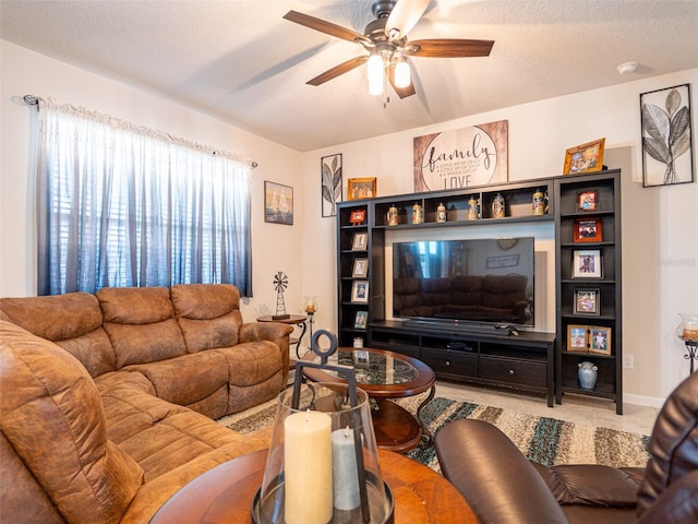 living room featuring a textured ceiling and a ceiling fan