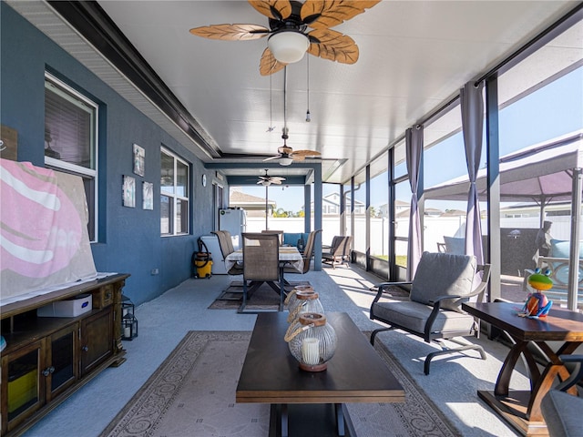 sunroom / solarium with a ceiling fan