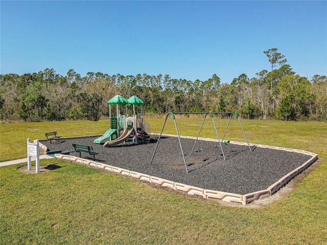 community jungle gym with a lawn