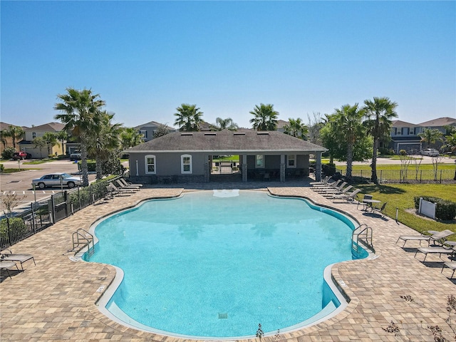 pool featuring a patio area and fence