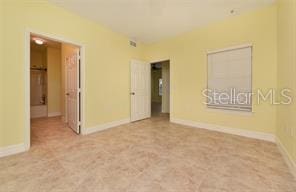 unfurnished room featuring baseboards