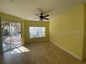 empty room featuring baseboards and a ceiling fan