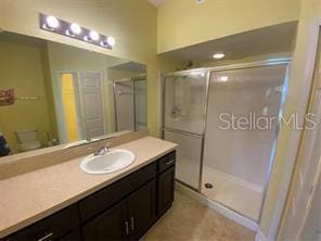 full bath with tile patterned floors, a shower stall, and vanity