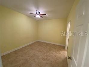 unfurnished room with baseboards