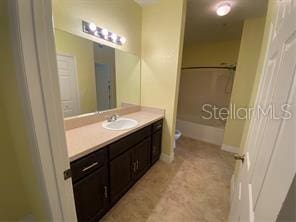 full bathroom featuring toilet,  shower combination, and vanity