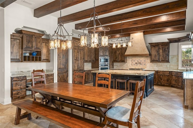 dining room featuring visible vents, beam ceiling, and a notable chandelier