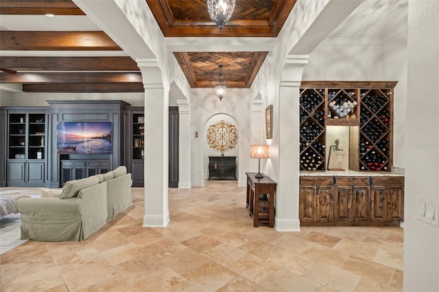 wine cellar with ornamental molding, stone finish flooring, coffered ceiling, beamed ceiling, and baseboards