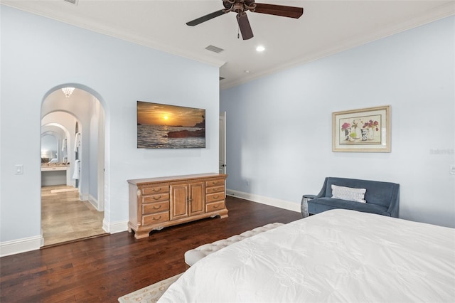 bedroom featuring arched walkways, dark wood-style flooring, recessed lighting, ornamental molding, and baseboards