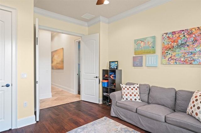 living room with crown molding, baseboards, ceiling fan, and wood finished floors