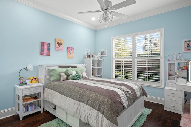 bedroom with baseboards, ceiling fan, wood finished floors, and crown molding