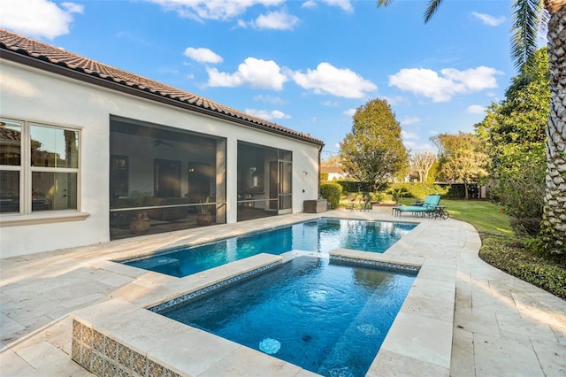 outdoor pool with a patio, fence, a sunroom, and an in ground hot tub