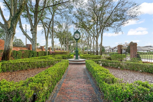 view of home's community featuring fence