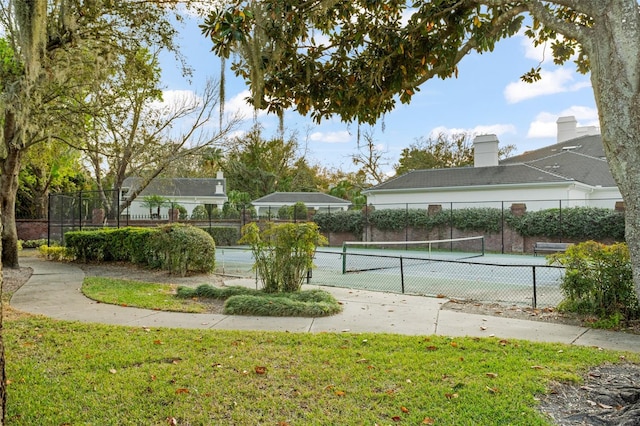 view of tennis court featuring fence