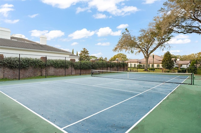 view of tennis court featuring fence