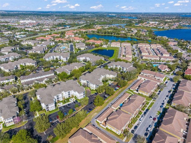 drone / aerial view with a water view and a residential view